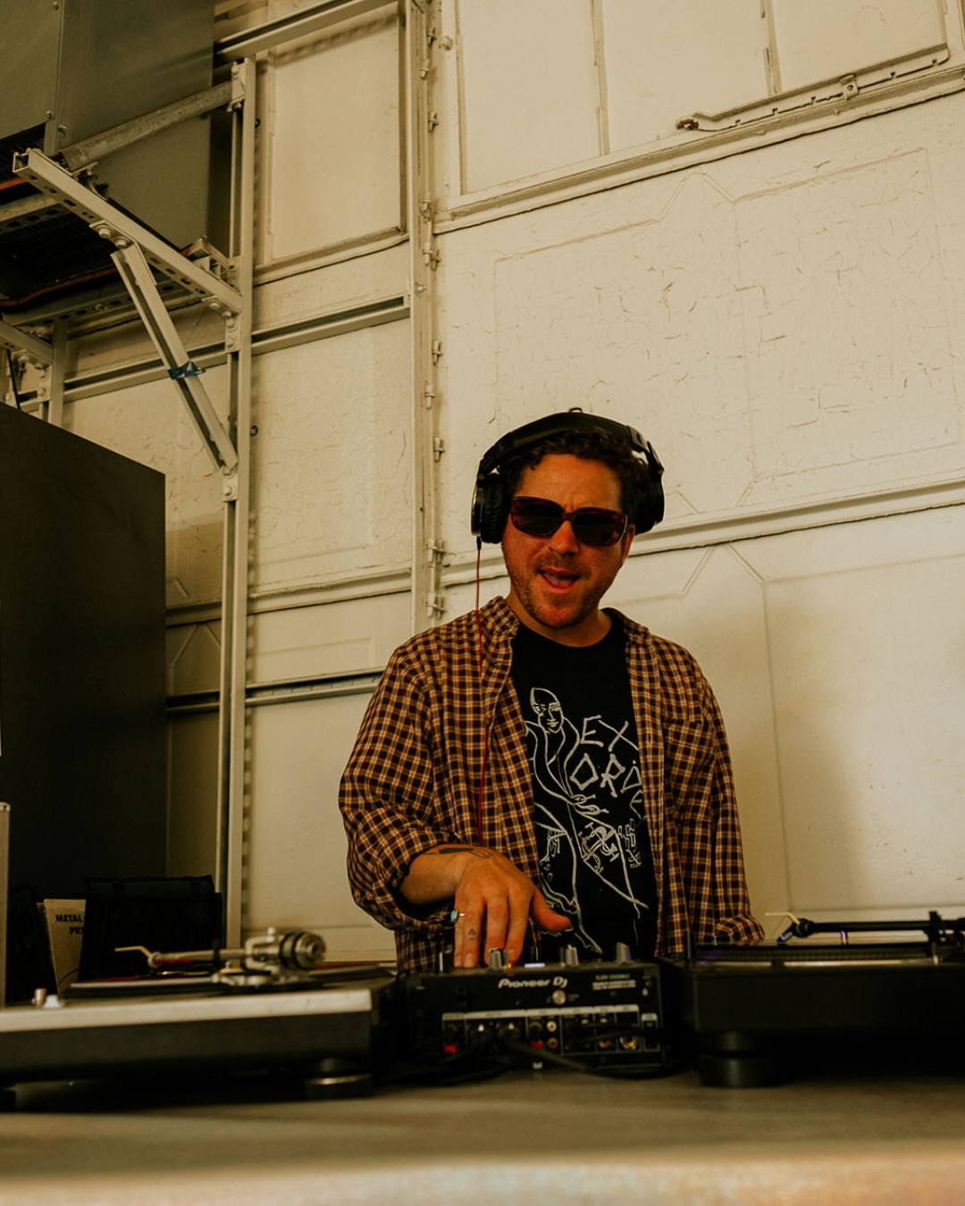 A DJ spinning vinyl on Pioneer turntables